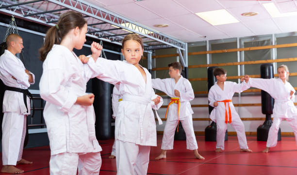 istock School girls practicing new karate moves in pairs 1407373252