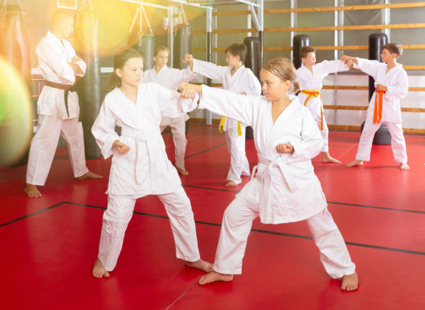 istock School girls practicing new karate moves in pairs 1407373257