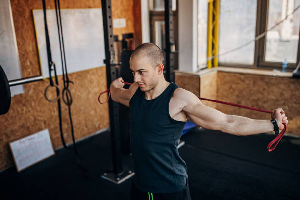 istock Man exercising in gym 1407373895