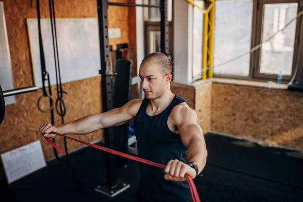 istock Man exercising in gym 1407373912