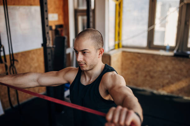 istock Man exercising in gym 1407373920