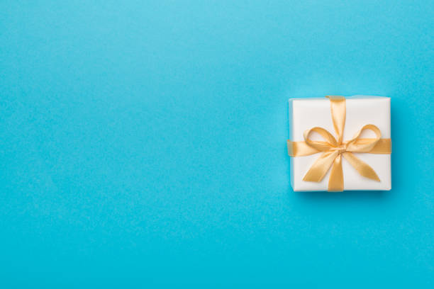 istock White gift box on color background, top view 1407377526