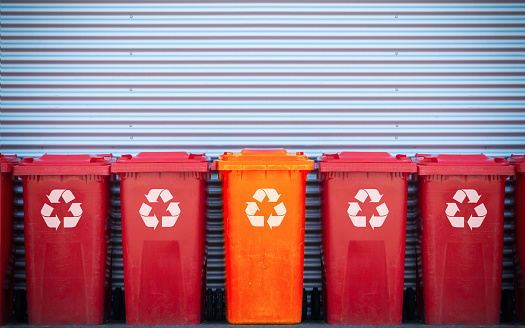 Red Plastic Waste Container Or Wheelie Bin, Isolated On White Vertical Background, Close Up