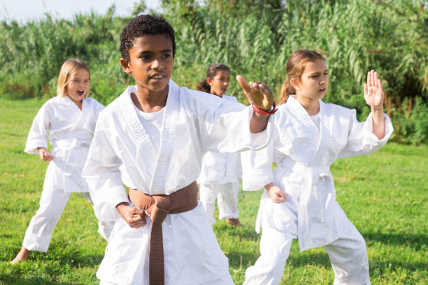 istock Group of kids in white kimono training 1407380628