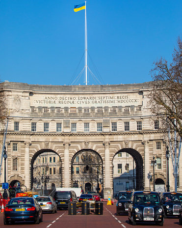 London, UK - March 8th 2022: The Ukrainian flag flying proudly above Admiralty Arch in London, UK.  The flag is displayed in support of Ukraine against Russian aggression.