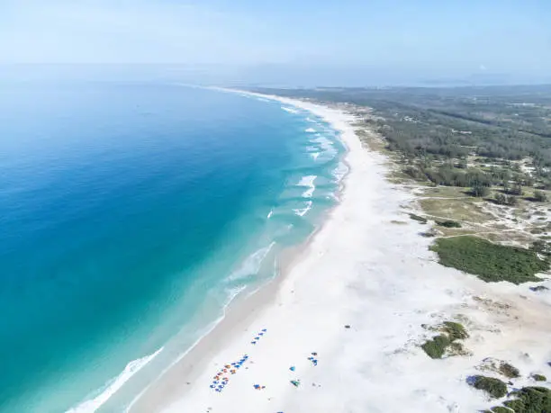 Wonderful coast of the Atlantic Ocean in the midst of nature, mountains, forests and a small coastal town. Drone aerial view. Arraial do Cabo, Rio de Janeiro, Brazil