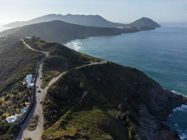 Wonderful coast of the Atlantic Ocean in the midst of nature, mountains, forests and a small coastal town. Drone aerial view. Arraial do Cabo, Rio de Janeiro, Brazil