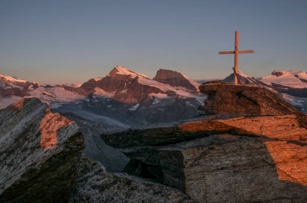 istock Scenic view of a religious cross on mountain peak 1407381833