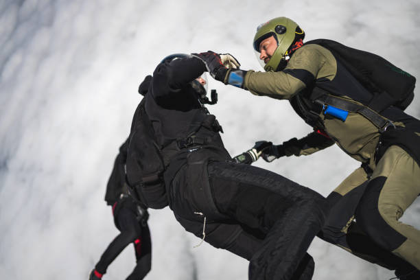 Skydivers fall through clear skies, aerial flight