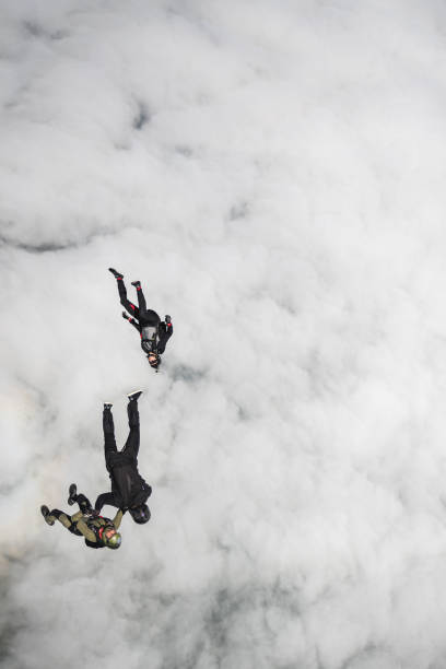 istock Skydivers fall through clear skies, aerial flight 1407381860