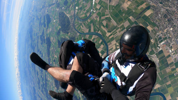istock Skydiver falls through clear skies, aerial flight 1407381885