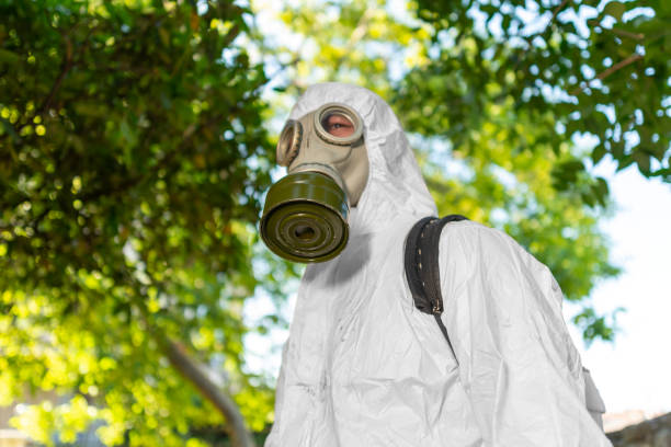 istock Man spraying insecticide on grass in lawn. 1407382024