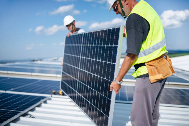 istock Teamwork is dreamwork. Team of electricins installing solar panels on warehouse roooftop. 1407383846