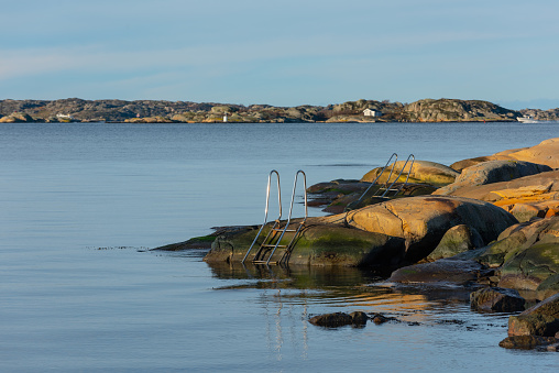 Gothenburg, Sweden - november 21 2021: Bathing ladder bolted to the cliffs at Fiskebäcksbadet.
