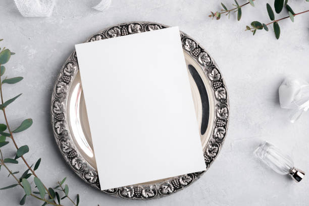 istock Wedding invitation card mockup 5x7 on silver retro vintage plate on grey background with eucalyptus, Menu card mockup 1407385726