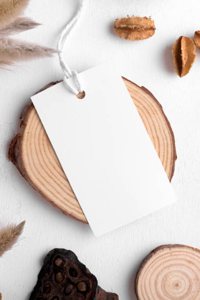 istock Rectangle white tag mockup on a white background with cotton string and boho decoration, dry plants, element for packing 1407386279