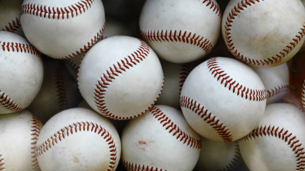 official baseball balls piled up - honkbal stockfoto's en -beelden