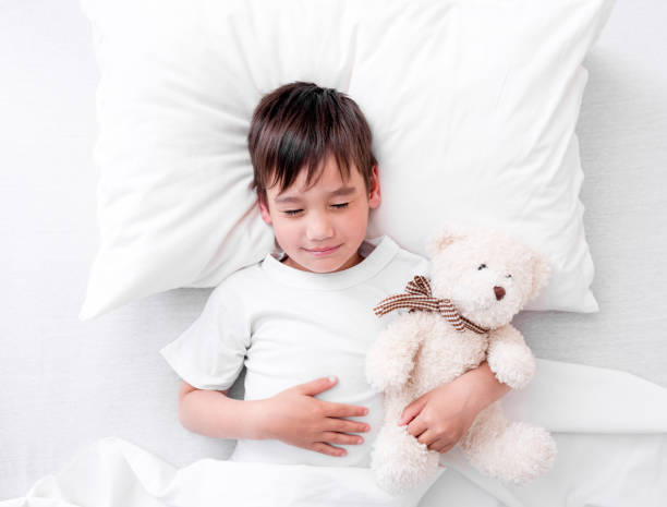 istock Toddler boy sleeping with teddy bear 1407389710