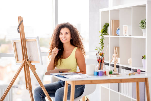 istock Artist sitting next to easel 1407390528