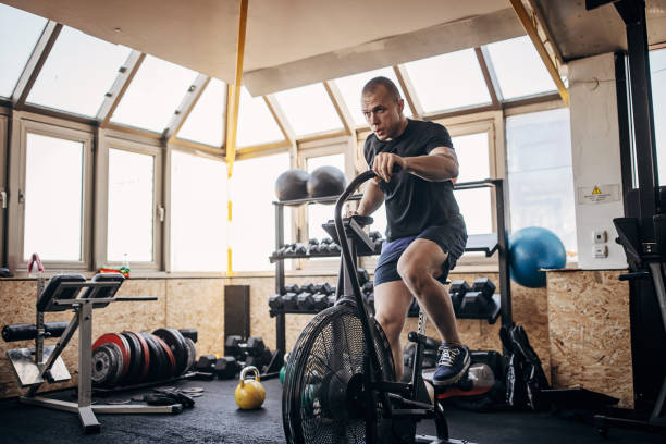 istock Man exercising on exercise bike 1407392194