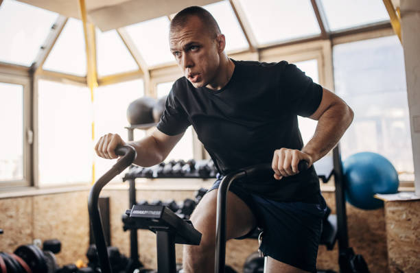 istock Man exercising on exercise bike 1407392207