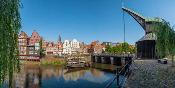 Panoramic view of the Stintmarkt on the Ilmenau with the Old Water Crane and historic houses in the old town of Lüneburg in Lower Saxony
