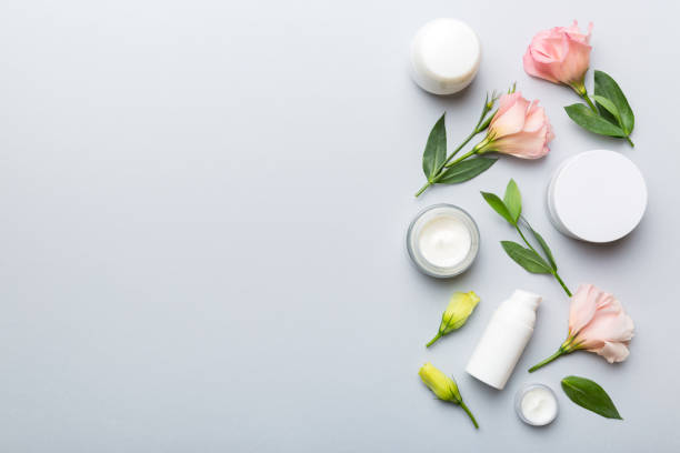 istock Composition with cosmetic products and beautiful roses on color background. Copy space, flat lay 1407399642