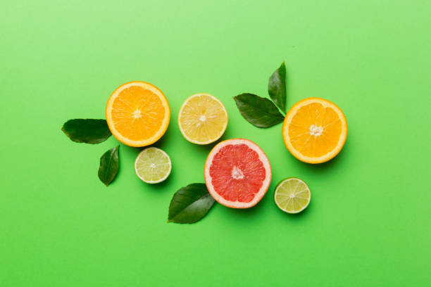 istock Fruit background. Colorful fresh fruits on colored table. Orange, lemon, grapefruit Space for text healthy concept. Flat lay, top view, copy space 1407399682