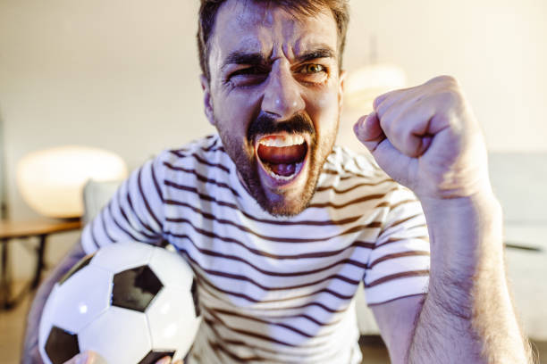 istock Cheering while watching a sports game at home 1407403354