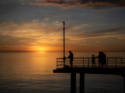 Brighton pier, South Australia in silhouette at sunset