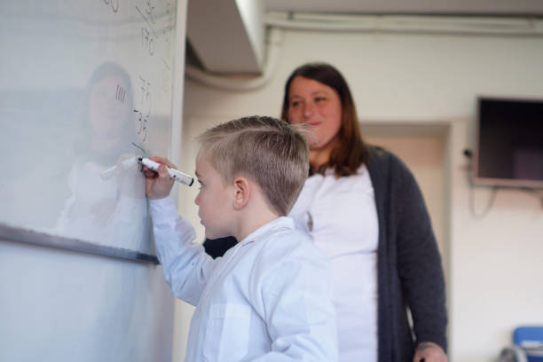 istock students with a teacher on the blackboard 1407414485