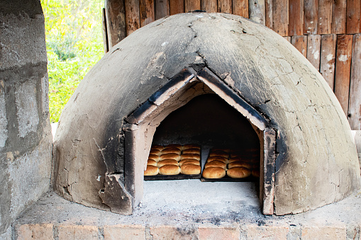 The home oven with just baked buns in it. Traditionally used in villages. Ecuador. Azuay province, Nabon canton.