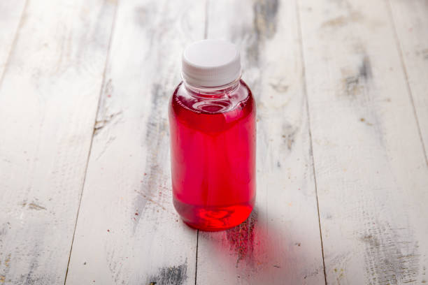 istock a bottle of red compote on white wooden table 1407418918
