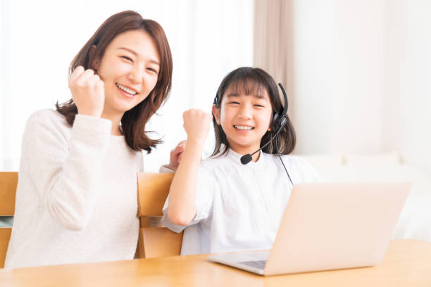 istock girl studying with a PC,correspondence course, mother and daughter 1407420005