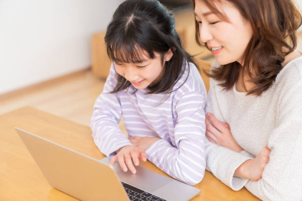 istock parent and daughter,laptop computer, 1407420238