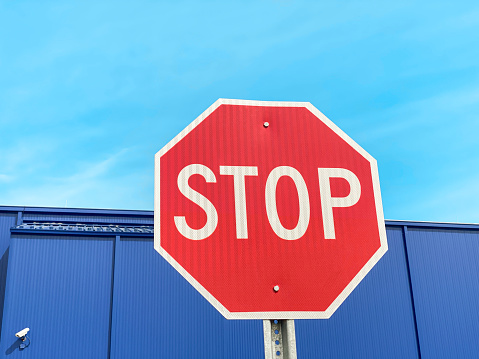 Stop sign in front of a warehouse