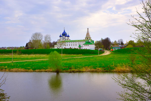 The old Kremlin on the river bank. Cathedral of the Nativity of the Virgin in the distance, architecture of the XIII-XVI centuries. Suzdal, Russia, 2022