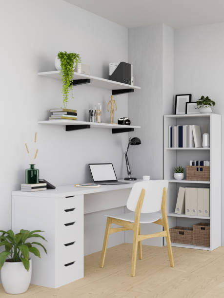 istock Modern white home or apartment workspace interior with studio desk, bookcase, and shelf on wall 1407425525