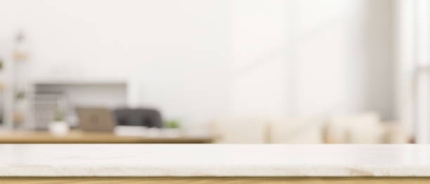 istock Copy space on empty white tabletop over blurred modern living room in the background. 1407425530