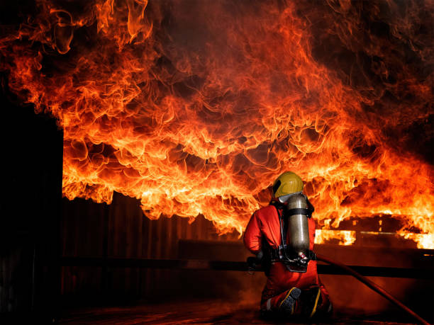 istock Fireman fighting with heavy fire overhead of him 1407429556