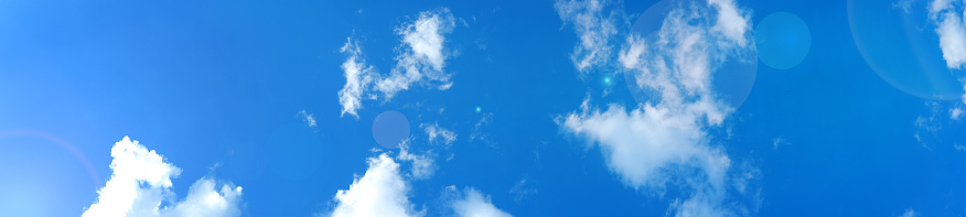 Blue sky with beautiful clouds and sunlight, banner format.