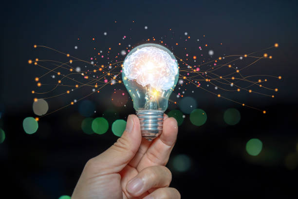 istock Light bulb with brain inside the hands of the businessman. 1407435524