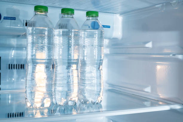 istock Cold bottles of clean drinking water in a white refrigerator 1407435729