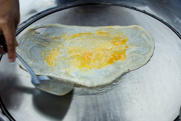 istock Top view of Fried delicious Roti topping with egg, focus selective 1407436353