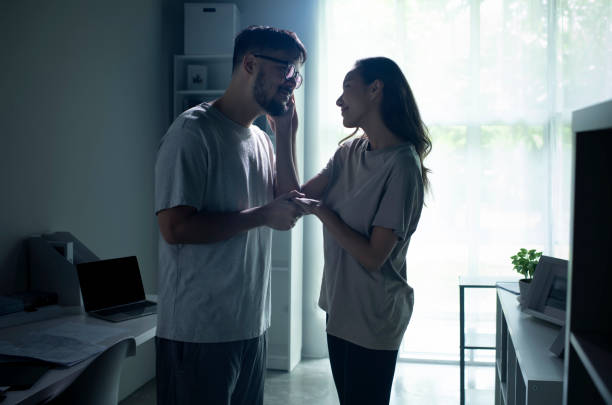 istock Young Asian couple holding hands and making up after a fight. 1407441027