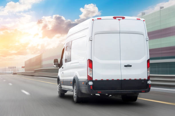 white mini bus is moving motion blur along city highway bypass road with beautiful sky before sunset. fast express delivery service of goods and parcels. - personal land vehicle imagens e fotografias de stock