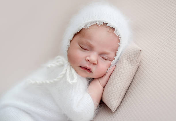 istock Newborn in white suit and diadem 1407447344
