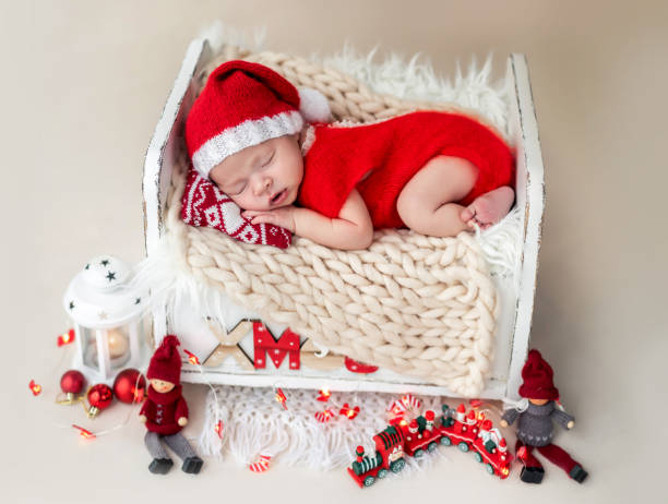 istock Newborn in santa suit resting on bed 1407447372