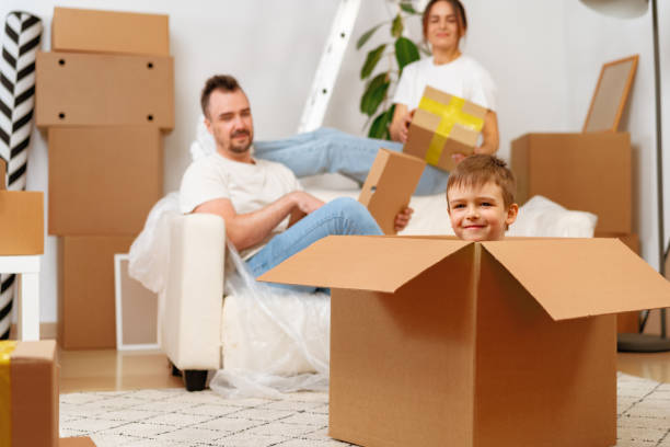 istock Parents and son packing boxes and moving into a new home 1407448261