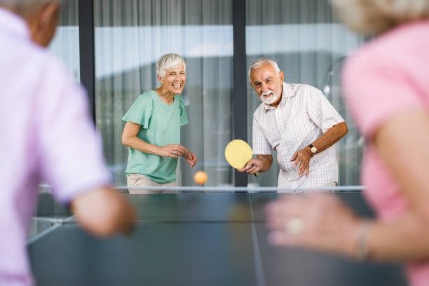 istock Playful seniors having fun while playing table tennis. 1407449229